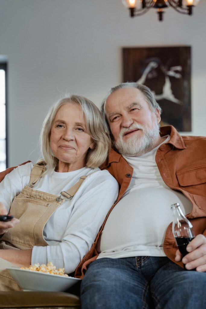 Happy senior couple enjoying a cozy time together indoors.